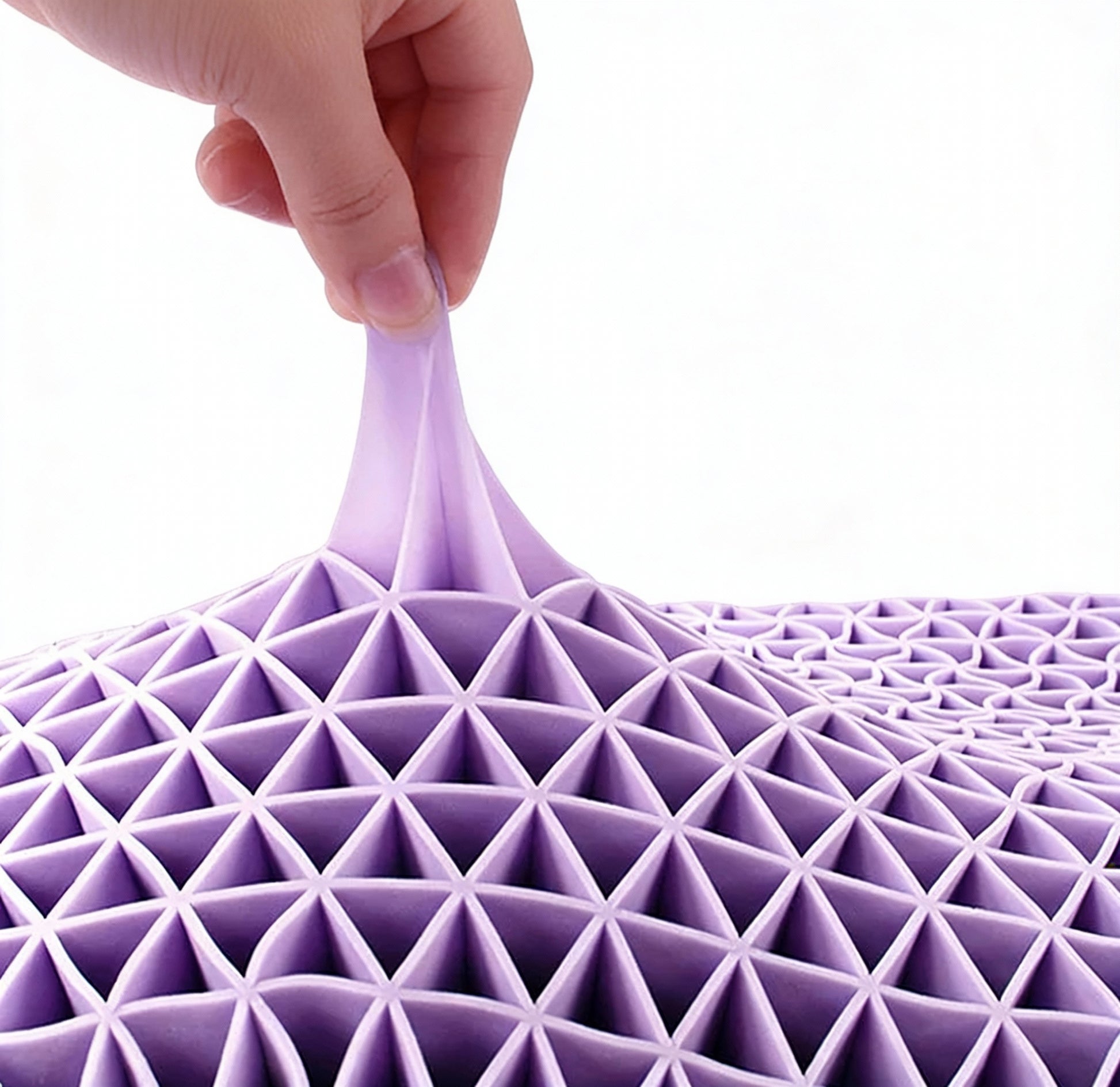 Hand pulling a piece of purple geometric fabric against a matching white background