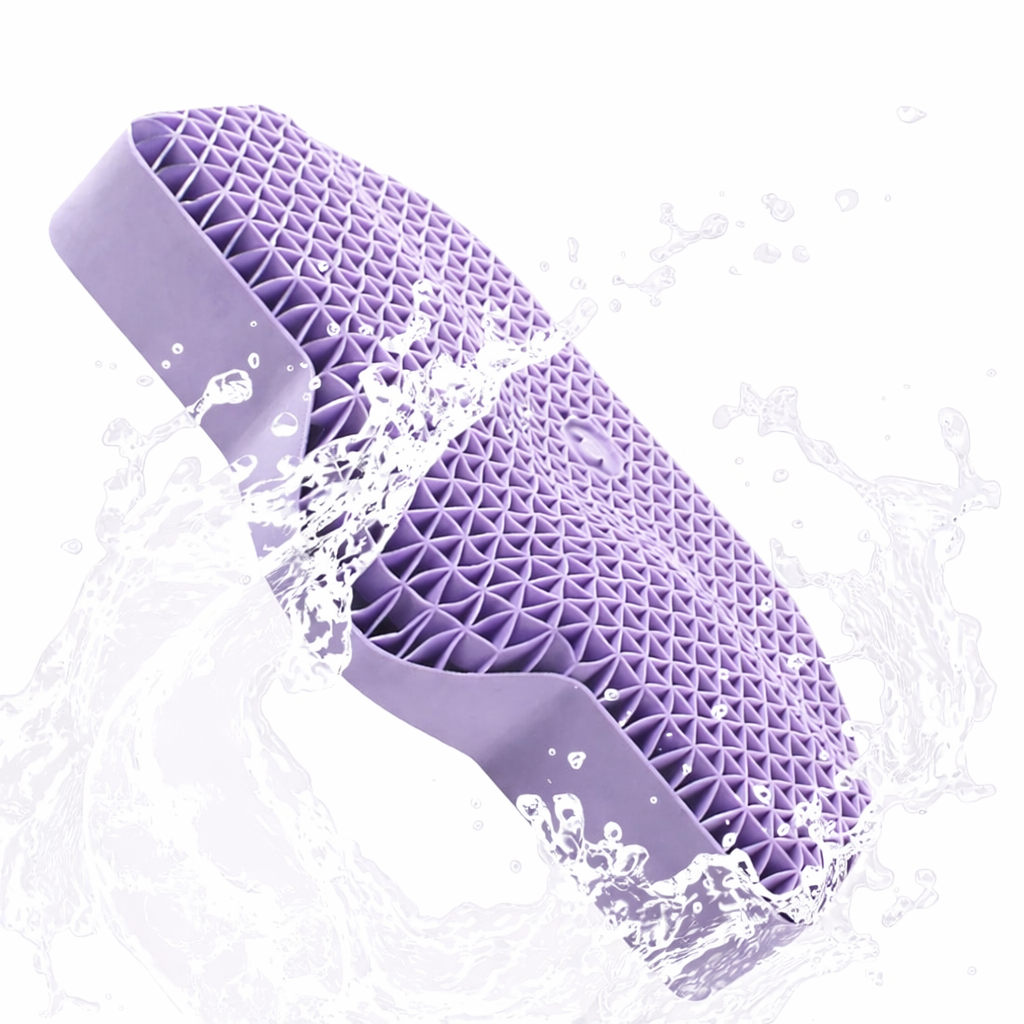 Purple silicone brush with water droplets on a white background