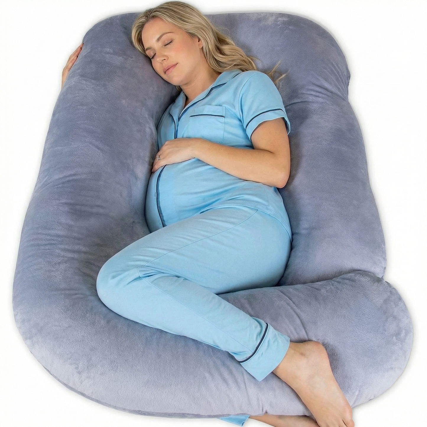 Woman sleeping on a large U-shaped body pillow with a white background